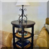 F37. Round side table with black painted legs. 30” x 24” 